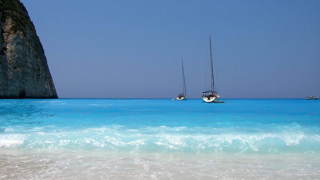 beach and sail boats in Greece